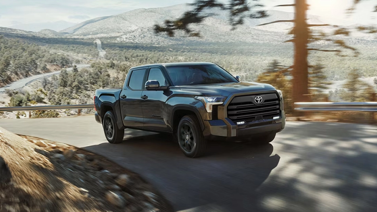 A charcoal gray Toyota Tundra driving on a mountain road