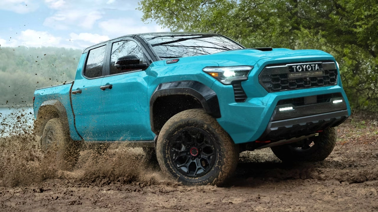 2026 Toyota Tacoma in turquoise blue, off-roading in the mud