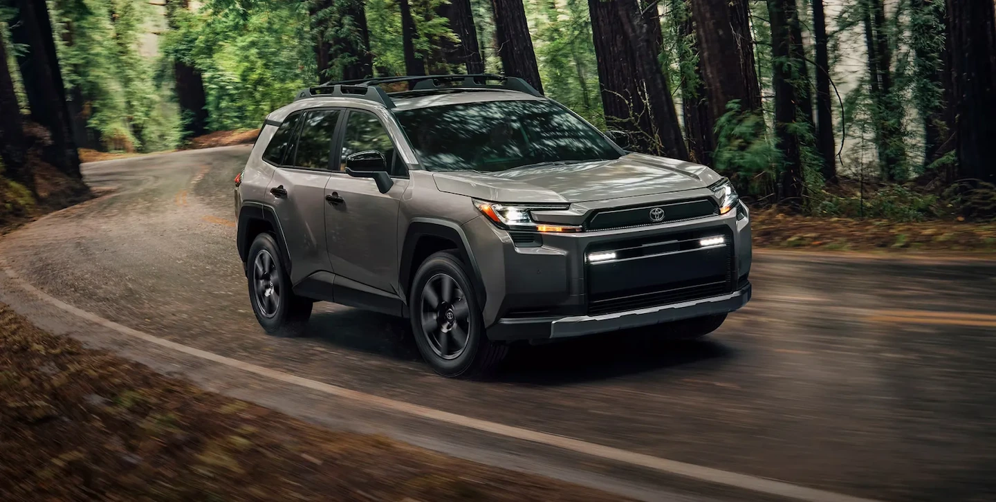 Toyota RAV4 Woodland Edition on a forest road, illustrating paint defect and corrosion warranty coverage.