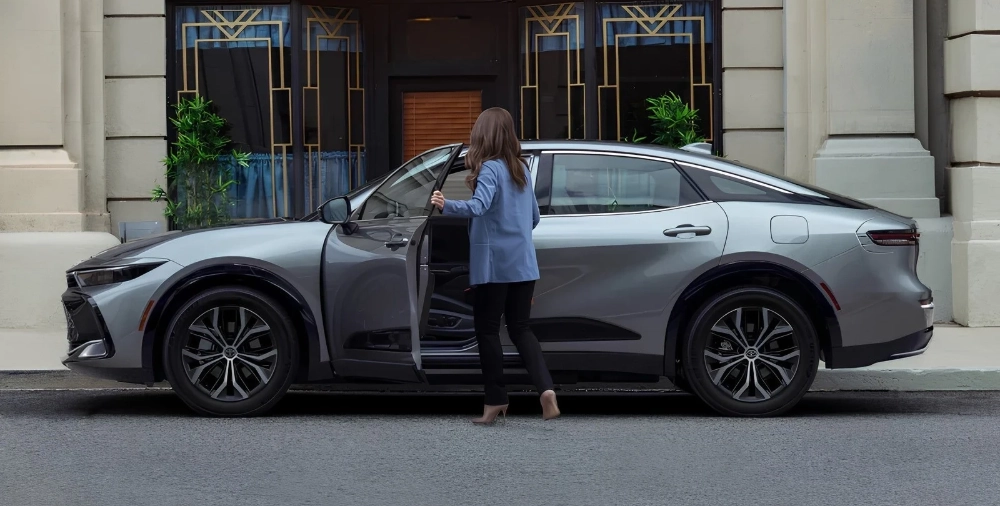Grey Toyota Crown Hybrid with an open door in the section about Toyota warranty exclusions.
