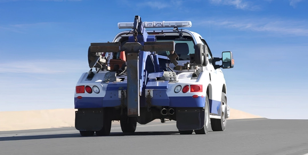 Tow truck on the road, illustrating towing included with Toyota roadside assistance.