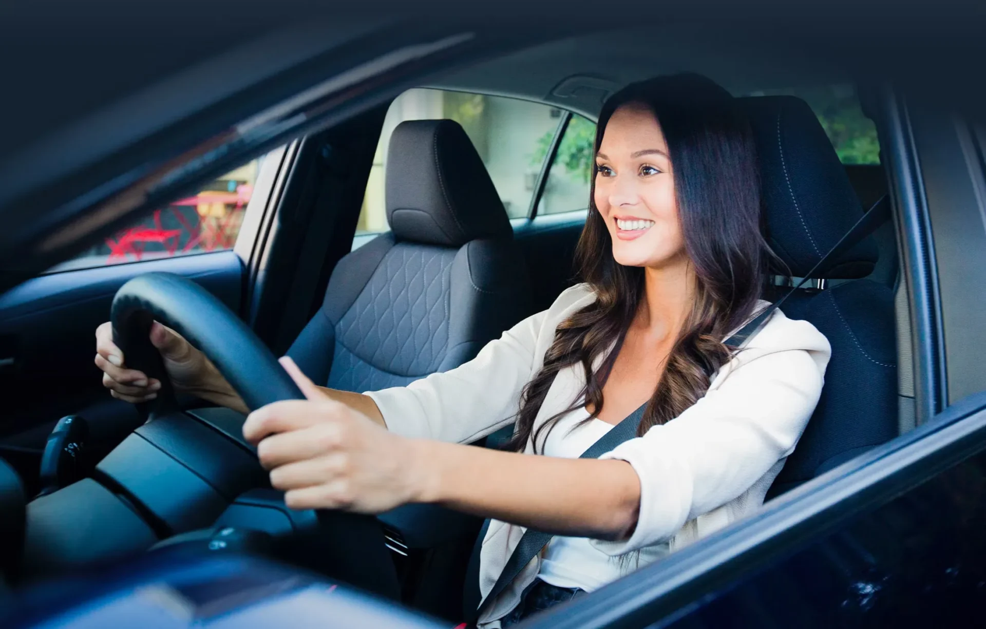Smiling driver behind the wheel of a vehicle, illustrating the benefits of Toyota extended coverage.