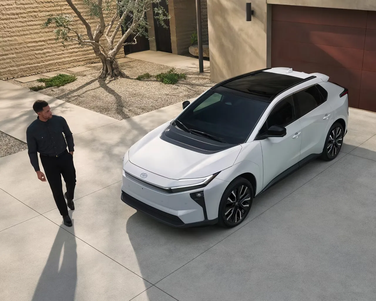 White 2026 Toyota bZ in front of a home, illustrating Toyota electric vehicle warranty coverage.